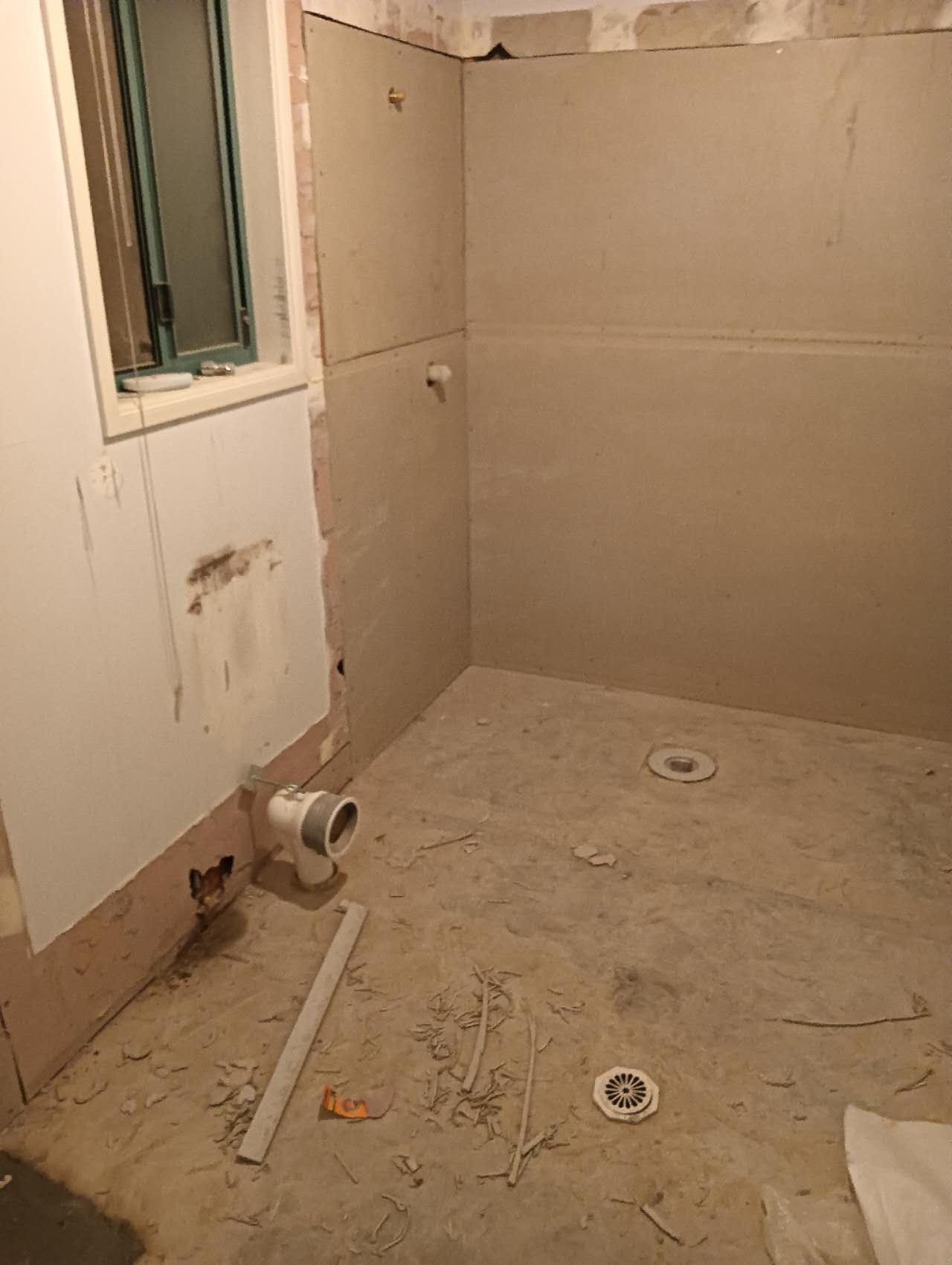 Prepared bathroom base with shower area and drainage points