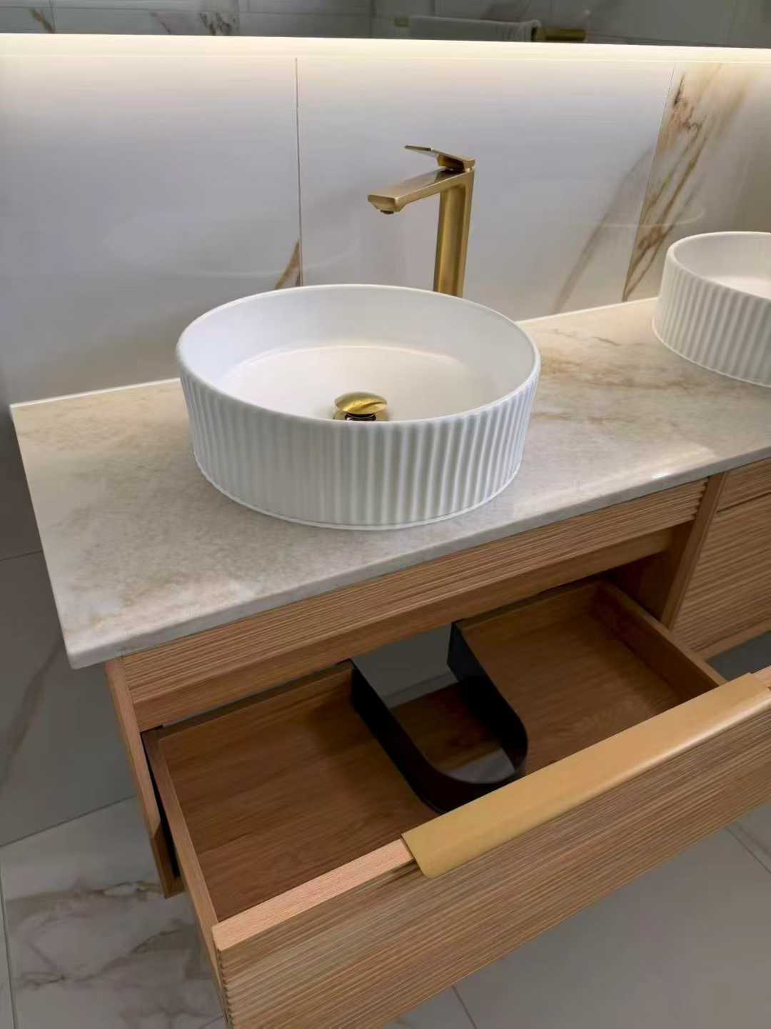 Double timber vanity with fluted white basins and brushed-gold taps