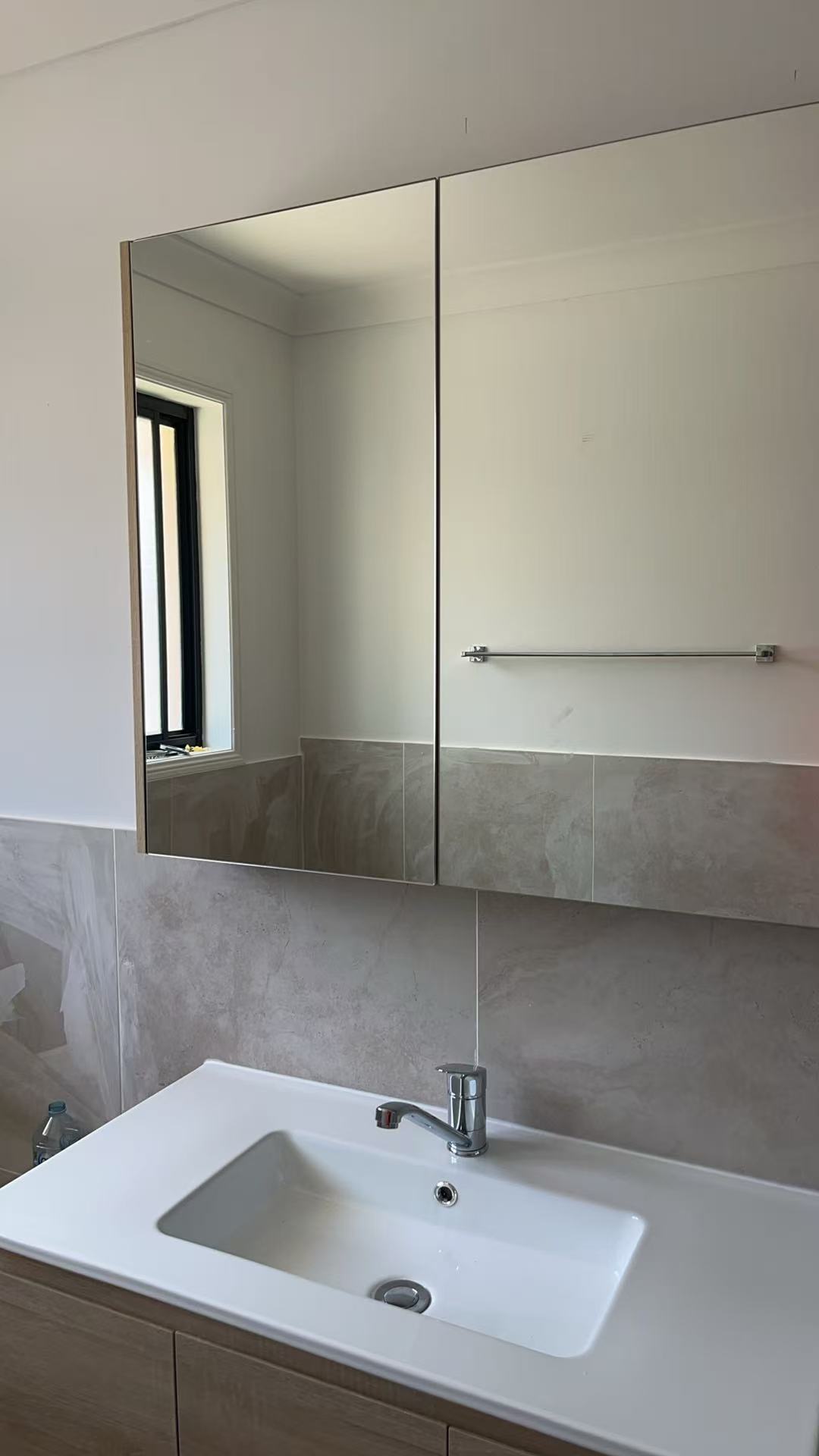 Completed timber vanity with inset basin, chrome tap and wide mirrored cabinet